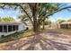 Large backyard featuring mature trees, providing ample shade and a serene outdoor space at 1204 Howell Creek Dr, Winter Springs, FL 32708