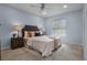 Comfortable bedroom with a ceiling fan, carpeted floors, and a large window for natural light at 1204 Howell Creek Dr, Winter Springs, FL 32708
