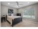 Well-lit bedroom with ceiling fan, comfortable bed, and view of backyard at 1204 Howell Creek Dr, Winter Springs, FL 32708