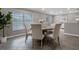 Elegant dining room with large window, round table, seating for six, and decorative art at 1204 Howell Creek Dr, Winter Springs, FL 32708