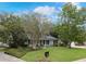 Charming single-story home featuring a welcoming front lawn, painted brick, and yellow front door at 1204 Howell Creek Dr, Winter Springs, FL 32708
