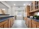 Kitchen with wood cabinets, dark countertops, tile flooring, and an open floor plan at 1204 Howell Creek Dr, Winter Springs, FL 32708
