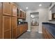 Kitchen featuring wooden cabinets, dark counter tops, and an open view into the living room at 1204 Howell Creek Dr, Winter Springs, FL 32708