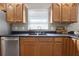 The kitchen sink is surrounded by lots of counterspace and storage in this bright neutral kitchen at 1204 Howell Creek Dr, Winter Springs, FL 32708