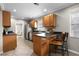Kitchen with stainless appliances, dark countertops, wood cabinets, and tiled floors at 1204 Howell Creek Dr, Winter Springs, FL 32708