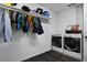 Bright laundry room features front-load washer and dryer, utility sink, and storage shelves for convenience at 1204 Howell Creek Dr, Winter Springs, FL 32708