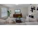 Cozy living room features modern decor, plush sofas, and a large TV at 1204 Howell Creek Dr, Winter Springs, FL 32708