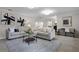 Spacious living room with comfortable sofas, stylish rug, and natural lighting at 1204 Howell Creek Dr, Winter Springs, FL 32708