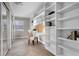 Bright home office with built-in shelving, desk, and mirrored sliding-door closet at 1204 Howell Creek Dr, Winter Springs, FL 32708