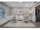 Cozy sitting room with two cushioned chairs, an accent cabinet, decorative rug, and neutral tones at 1204 Howell Creek Dr, Winter Springs, FL 32708