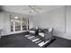 Inviting sunroom with gray and white decor, wicker chairs, and a ceiling fan for comfort at 1204 Howell Creek Dr, Winter Springs, FL 32708