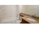 Bathroom featuring a granite countertop vanity, tub, and white tile walls at 122 Vista Verdi Cir # 236, Lake Mary, FL 32746