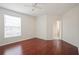 Sunny bedroom with hardwood floors, a ceiling fan, and an en-suite bathroom at 122 Vista Verdi Cir # 236, Lake Mary, FL 32746
