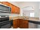 Charming kitchen with granite countertops, stainless appliances, and open view to living area at 122 Vista Verdi Cir # 236, Lake Mary, FL 32746