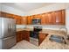 Modern kitchen with stainless steel appliances, granite countertops, and wood cabinets at 122 Vista Verdi Cir # 236, Lake Mary, FL 32746