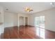 Spacious living room featuring hardwood floors, built-in shelves, and balcony access at 122 Vista Verdi Cir # 236, Lake Mary, FL 32746