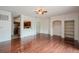 Open-concept living room with hardwood floors, shelving, and an opening to the kitchen at 122 Vista Verdi Cir # 236, Lake Mary, FL 32746