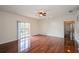 Bright living room with wood floors, ceiling fan, and a sliding glass door to the balcony at 122 Vista Verdi Cir # 236, Lake Mary, FL 32746