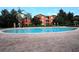 Community pool on brick patio with nearby apartment homes and lush tropical landscaping at 122 Vista Verdi Cir # 236, Lake Mary, FL 32746