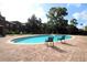 Community pool with chairs on a sunny day, perfect for relaxing and socializing at 122 Vista Verdi Cir # 236, Lake Mary, FL 32746