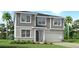 Charming two-story home features a two-car garage, neutral colors, and stone accents at 13240 Pergola Ave, Orlando, FL 32832