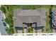 Aerial view of a townhouse showcasing its tile roof, landscaping, and proximity to other houses at 13993 Tarvin St, Orlando, FL 32832