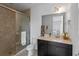 Bathroom features a glass enclosed shower, granite counters and dark vanity at 13993 Tarvin St, Orlando, FL 32832