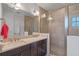 Bathroom featuring a glass enclosed shower and double sink vanity at 13993 Tarvin St, Orlando, FL 32832