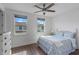 Bright bedroom with two windows, ceiling fan and wood-look flooring at 13993 Tarvin St, Orlando, FL 32832