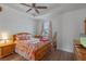 Bedroom features wood floors, pink accents, and a large window for natural light at 13993 Tarvin St, Orlando, FL 32832