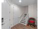Bright entryway with wood floors, a staircase, and a cozy wicker chair for a warm welcome at 13993 Tarvin St, Orlando, FL 32832