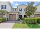 Charming townhouse boasts lush landscaping, a brick walkway, and a convenient two-car garage at 13993 Tarvin St, Orlando, FL 32832