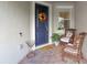 Cozy porch with seating, a colorful wreath on a blue door, and a 'Welcome' doormat at 13993 Tarvin St, Orlando, FL 32832