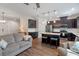 Open concept kitchen with stainless steel appliances, dark cabinetry, and an island at 13993 Tarvin St, Orlando, FL 32832
