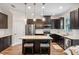 Modern kitchen boasts stainless steel appliances, dark cabinetry, and a stylish island with pendant lighting at 13993 Tarvin St, Orlando, FL 32832