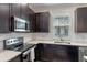 The kitchen offers stainless appliances, white subway tile backsplash, and shaker style cabinets at 13993 Tarvin St, Orlando, FL 32832