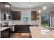 The kitchen has stainless steel appliances, dark cabinets, and an island that faces the sliding glass door at 13993 Tarvin St, Orlando, FL 32832