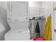 Laundry room with stacked washer and dryer and shelving unit at 13993 Tarvin St, Orlando, FL 32832