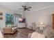 Cozy living room with a ceiling fan, tv, and view of the backyard at 13993 Tarvin St, Orlando, FL 32832