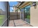 Screened patio with brick flooring and sliding glass door into home at 13993 Tarvin St, Orlando, FL 32832