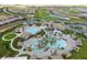Aerial view of resort style community with clubhouse, pools, and landscaping at 1466 Moon Valley Dr, Champions Gate, FL 33896