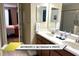 Well-lit bathroom with double sinks, spacious countertop, and a glimpse into the bedroom, creating convenience and comfort at 1466 Moon Valley Dr, Champions Gate, FL 33896