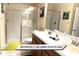 Bathroom with double sinks, glass-enclosed shower, and neutral décor at 1466 Moon Valley Dr, Champions Gate, FL 33896