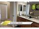 Ensuite bathroom featuring double sinks with granite countertops at 1466 Moon Valley Dr, Champions Gate, FL 33896