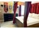 Charming themed bedroom with a four-poster bed and decorative banners at 1466 Moon Valley Dr, Champions Gate, FL 33896