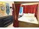 Comfortable themed bedroom with four-poster bed and decorative banners at 1466 Moon Valley Dr, Champions Gate, FL 33896