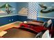 Whimsical bedroom with two race car beds and fun, colorful wall decor at 1466 Moon Valley Dr, Champions Gate, FL 33896