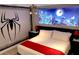 This bedroom features a queen-size bed, ceiling fan, and a custom mural that adds a playful and unique ambiance at 1466 Moon Valley Dr, Champions Gate, FL 33896