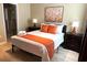 Cozy bedroom with a queen bed, decorative pillows, and neutral decor for a relaxing atmosphere at 1466 Moon Valley Dr, Champions Gate, FL 33896