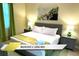 Bedroom with a king-size bed, green accents, and bright natural light at 1466 Moon Valley Dr, Champions Gate, FL 33896